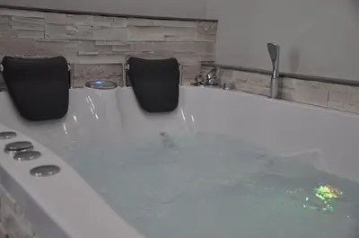 a bath tub with two chairs sitting next to it at Imperial Relais in Rome