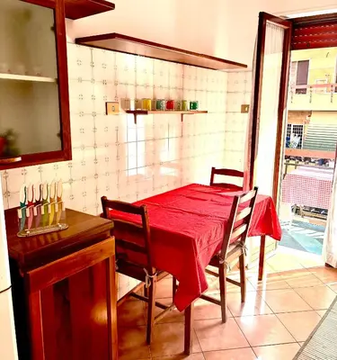 a dining room with a red table and chairs at Casa Rita 15 minuti dal centro in Rome