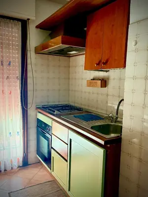 a small kitchen with a stove and a sink at Casa Rita 15 minuti dal centro in Rome