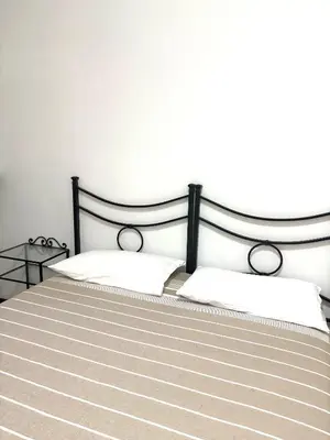 a bedroom with a bed with a black and white bedspread at Casa Rita 15 minuti dal centro in Rome