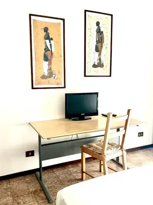 a room with a desk with a tv and a chair at Casa Rita 15 minuti dal centro in Rome