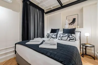 a bedroom with a large bed with towels on it at Acque Romane Maison Trevi Crociferi in Rome