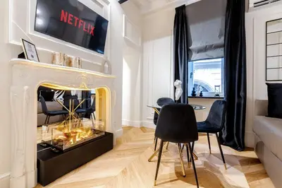a living room with a fireplace and a table and chairs at Acque Romane Maison Trevi Crociferi in Rome