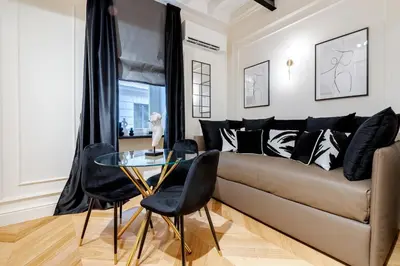 a living room with a couch and a glass table at Acque Romane Maison Trevi Crociferi in Rome