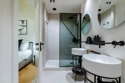 a bathroom with a shower and a sink and a mirror at Acque Romane Maison Trevi Crociferi in Rome