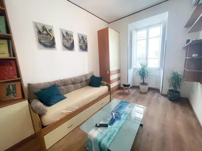 a kitchen with wooden floors and a white counter top at RM555 Elegant apartment in Rome