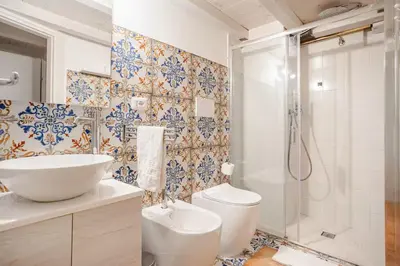 a bathroom with a toilet and a sink and a shower at La Casetta Aureliana in the center of the capital in Rome