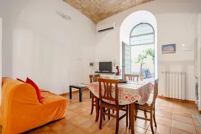 a living room with a table and a couch at La Casetta Aureliana in the center of the capital in Rome