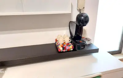 a counter top with a black shelf on a kitchen counter at La Casetta Aureliana in the center of the capital in Rome