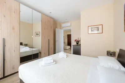 a bedroom with a white bed and a bathroom at ROMAN DREAM lV in Rome