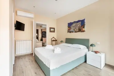 a bedroom with a large bed and a tv at ROMAN DREAM lV in Rome