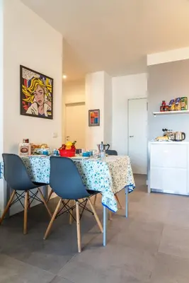a white kitchen with white cabinets and a sink at Trastevere Station Apartment View in Rome