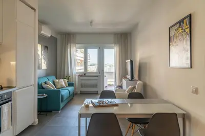 a dining room with a table and four chairs at Trastevere Station Apartment View in Rome