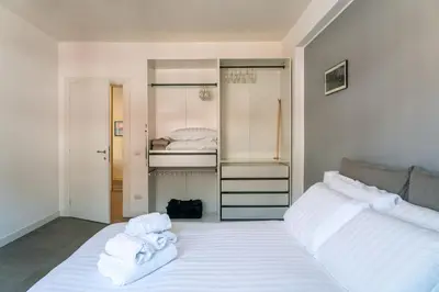a bedroom with two beds with white towels on them at Trastevere Station Apartment View in Rome