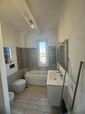 a bathroom with a tub and a toilet and a sink at Belvedere home in Rome