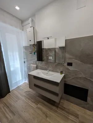 a bathroom with a white sink in a room at Maison Simone Marconi in Rome