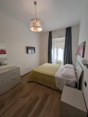 a bedroom with a bed and a window at Maison Maurizio Marconi in Rome