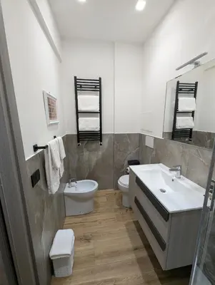 a bathroom with a sink and a toilet at Maison Maurizio Marconi in Rome