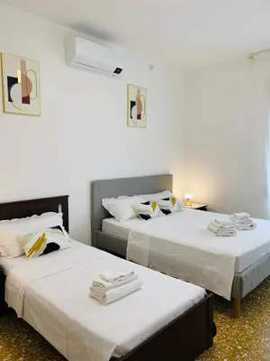 two beds sitting next to each other in a room at Appartamento Roma San Giovanni in Rome