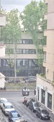 a parking lot with cars parked in front of a building at Appartamento Roma San Giovanni in Rome