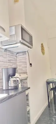a kitchen with a microwave on top of a counter at Appartamento Roma San Giovanni in Rome