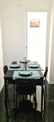 a table with black chairs and a blue table cloth at Appartamento Roma San Giovanni in Rome