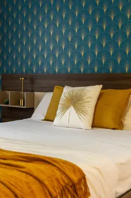 a bedroom with a large bed with a blue wall at Maia - Luxury Apartment in Monteverde in Rome