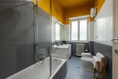 a bathroom with a tub and a toilet and a sink at Maia - Luxury Apartment in Monteverde in Rome