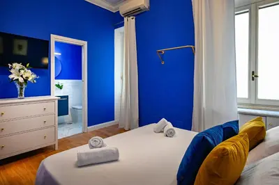 a blue bedroom with a bed with towels on it at Royal Blue - Holiday Apartment in Rome