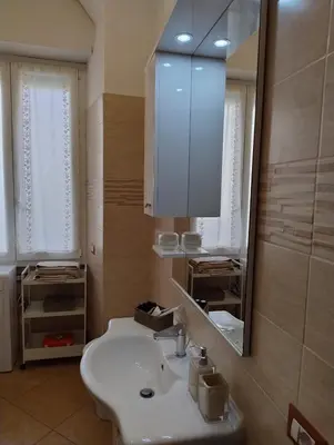 a bathroom with a white sink and a mirror at Alcinque - Casa vacanze in Rome