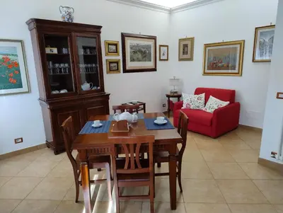 a living room with a table and a red couch at Alcinque - Casa vacanze in Rome