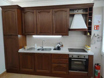 a kitchen with wooden cabinets and a sink at Alcinque - Casa vacanze in Rome