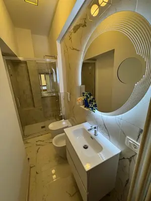 a bathroom with a sink and a toilet and a mirror at Suite 41 in Rome
