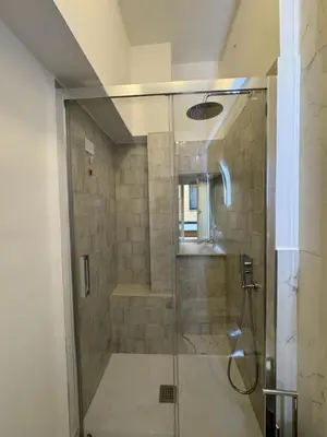 a shower with a glass door in a bathroom at Suite 41 in Rome