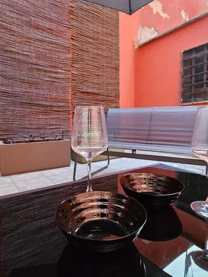 two wine glasses sitting on top of a table at San Lorenzo Garden Suites in Rome