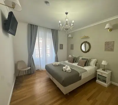 a bedroom with a large bed with a chandelier at Sweet Saint Paul in Rome