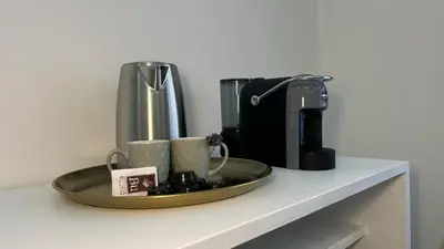 a tray with cups and a coffee maker on a counter at Sweet Saint Paul in Rome