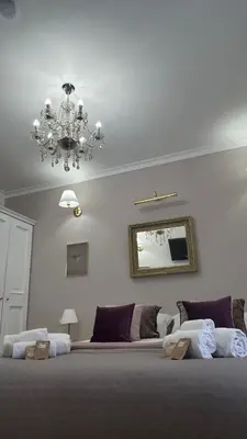 a bedroom with a large bed and a chandelier at Sweet Saint Paul in Rome