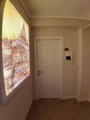 a hallway with a door and a painting on the wall at Saint Peter's Sunset View Luxury Apartment in Rome
