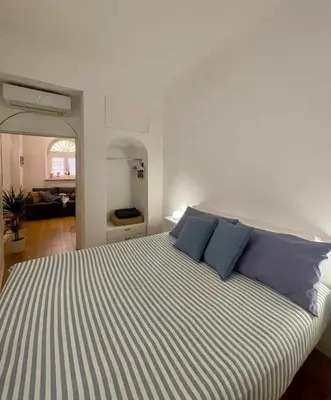 a bedroom with a large bed with blue pillows at Domus 31 - Colosseum in Rome