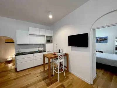 a kitchen with a table and a bed in a room at Domus 31 - Colosseum in Rome