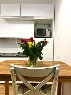 a vase of flowers on a table in a kitchen at Domus 31 - Colosseum in Rome