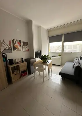 a living room with a table and a couch at Appia Suite in Rome