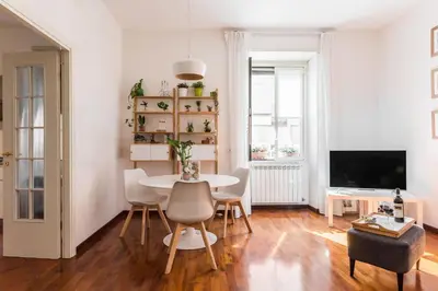 a living room with a table and chairs and a television at Line 8 House in Rome