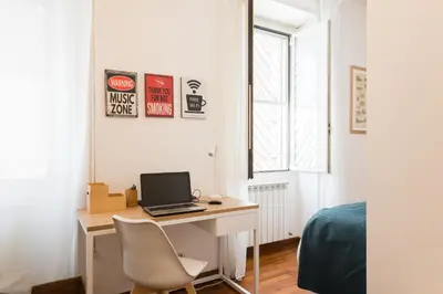 a bedroom with a desk with a laptop computer on it at Line 8 House in Rome