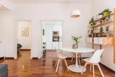 a living room with a white table and chairs at Line 8 House in Rome