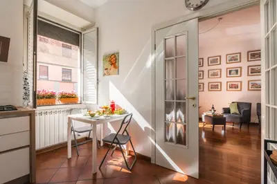 a small kitchen and dining room with a table at Line 8 House in Rome