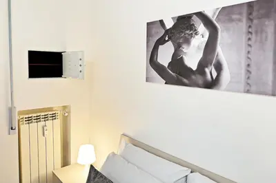 a black and white picture of a woman hanging on a wall at Roma Passion Suite in Rome