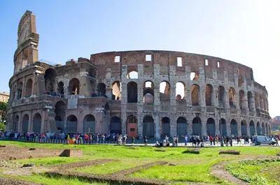 a group of people standing in front of the coliseum at Domus Aurea3 flat a stone's throw from Colosseum in Rome