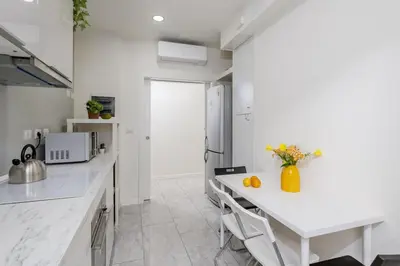 a kitchen with white counters and a white counter top at Domus Aurea3 flat a stone's throw from Colosseum in Rome